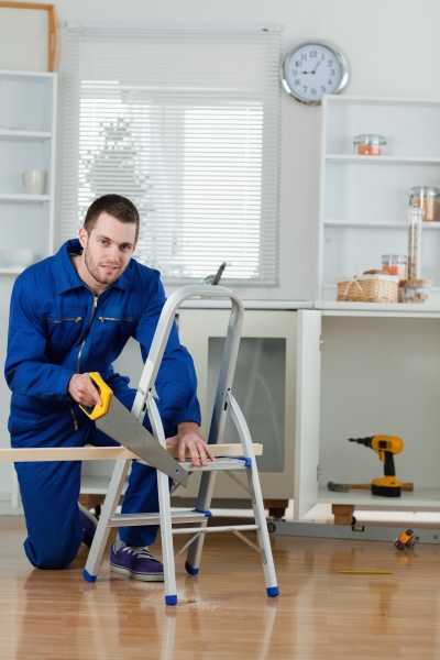 3641015-portrait-of-a-handyman-cutting-a-wooden-board